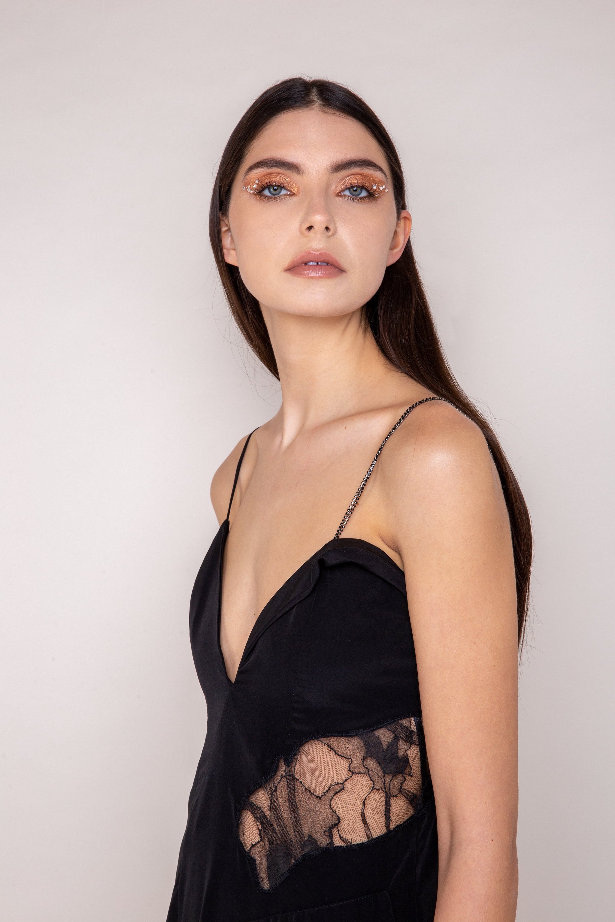Close-up of intricate French lace pattern and crystal strap on the Jasmine Dress - 100% recycled polyester